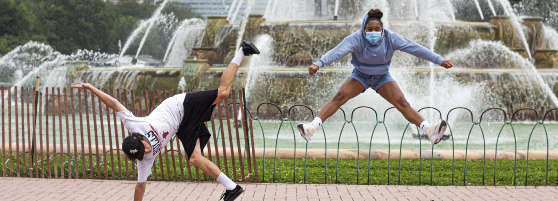 Students doing cartwheels in front of Buckingham Fountain.