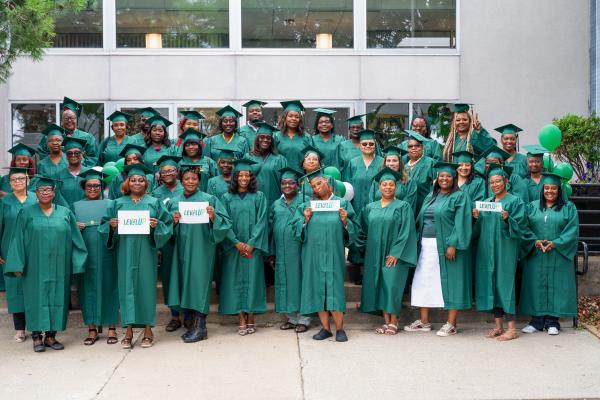 A group of graduates standing in front of a building.