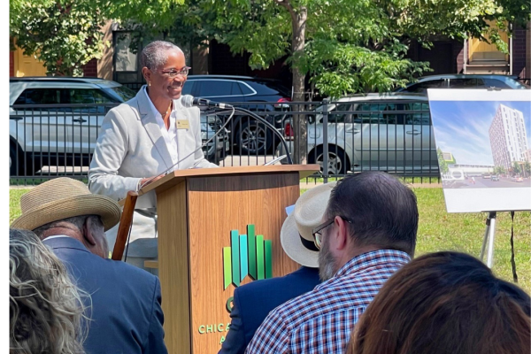 CEO Tracey Scott speaking at a podium,