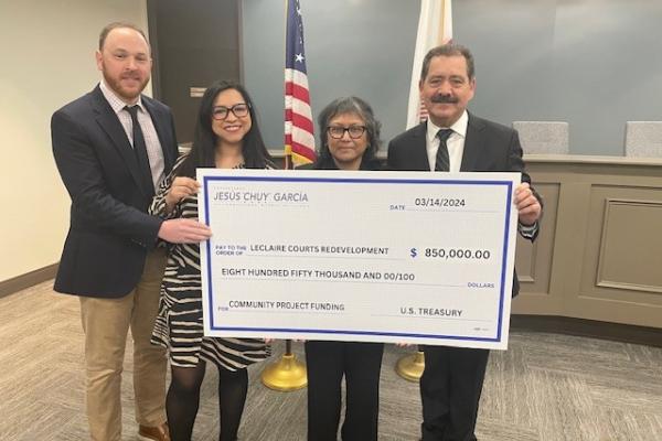 CHA Staff Pose with Representative Garcia and a large check representing $850,000 in funding for the LeClaire Courts Redevelopment