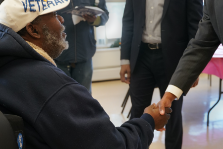 CHA leader shaking hands with a veteran.